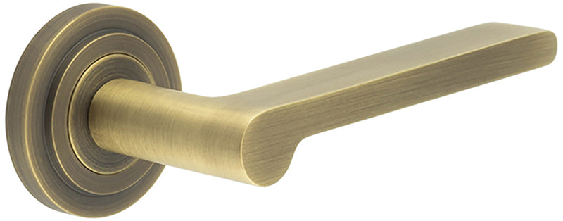 Blade Pattern Lever Handles With Stepped Round Rose - Suitable For Use With FD30 / FD60 Fire Doors - Antique Brass
