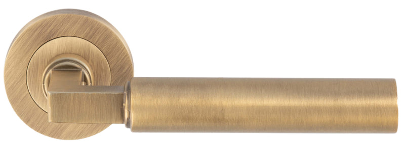 Tubular Lever Door Handles With Square Section Neck With Round Rose - Antique Brass