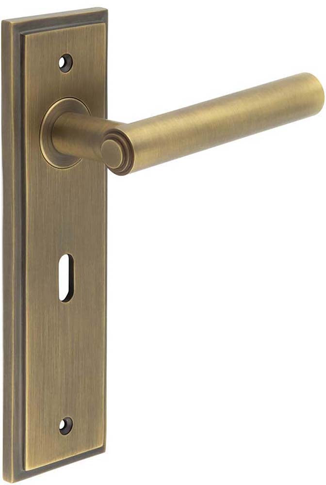 Tubular Pattern Lever Handle With Stepped Ends On A Large Rectangular Backplate - Antique Brass