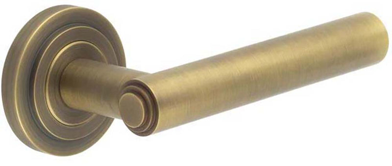 Tubular Pattern Lever Handles With Stepped Ends On Stepped Round Rose - Suitable For Use With FD30 / FD60 Fire Doors - Antique Brass